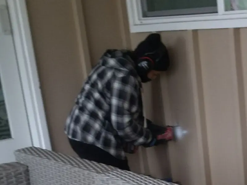 Professional electrician installing an exterior outlet in Raisin